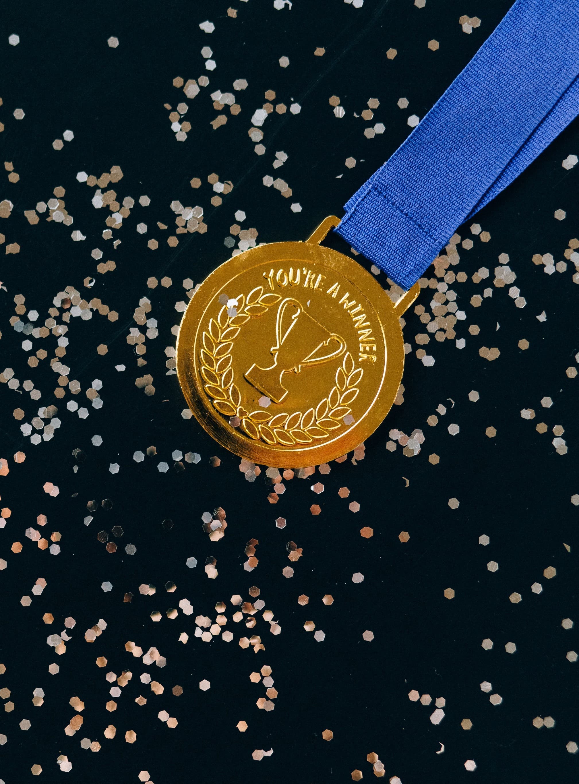 Gold winner medal with blue ribbon